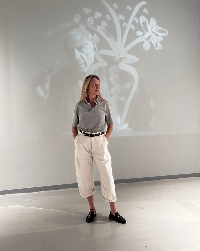 Grey polo and cream trousers in a white gallery